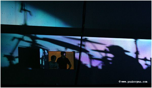 (Digital Image) Edmonton, AB: April 5, 2007: The shadow of drummer Shannon Leto with 30 Seconds to Mars falls on two fans while