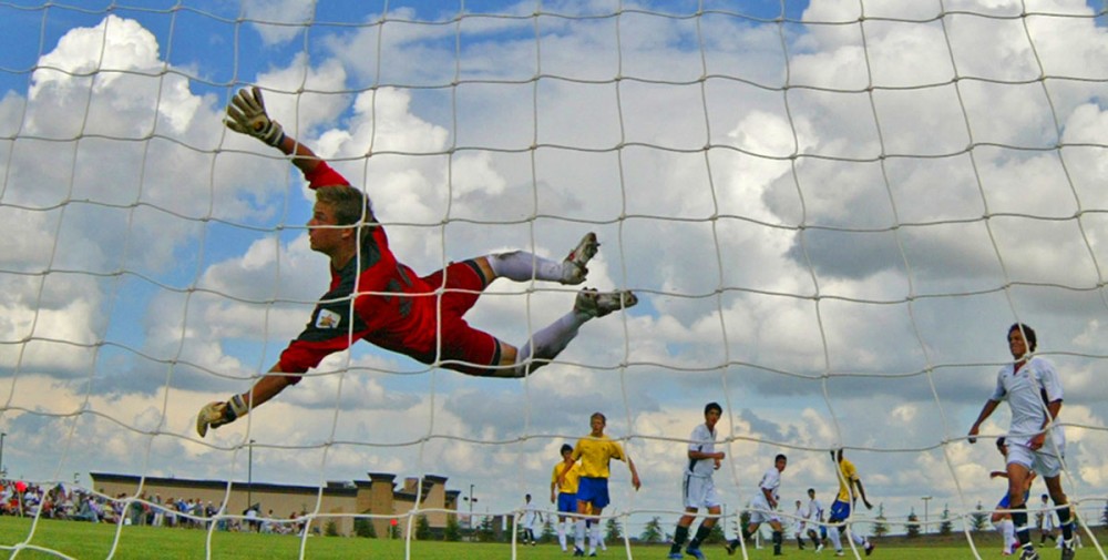 Team Alberta's goalie Brad Hughes dives for the ball which went foul during their game against Team B.C.  at the 2007 Western Canada Summer Games.