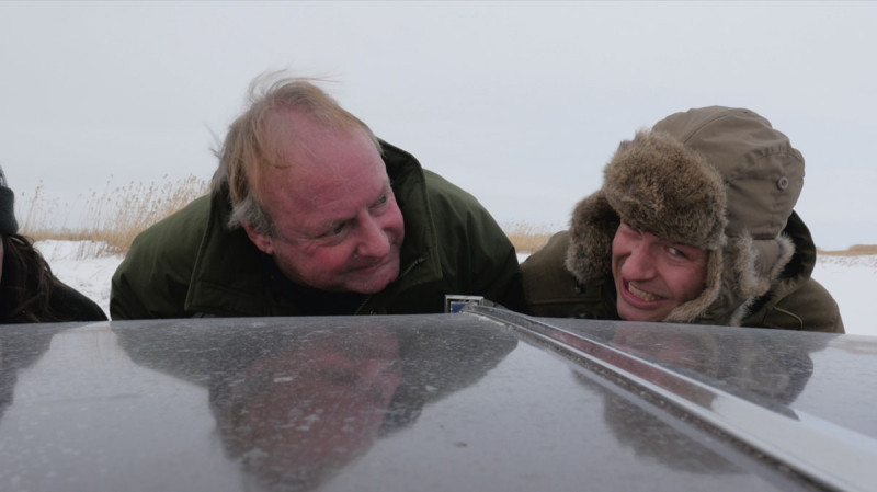 Journal reporter Marty Klinkenberg, left, and photographer Ryan Jackson try to push Isaias Morgan’s vehicle after he got stuck in a snow bank after losing control along the winter ice road from Fort McMurray to Fort Chipewyan.