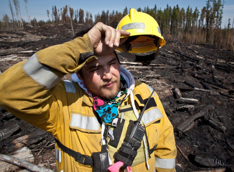 Marcel Desjarlais, Crew Leader with Alberta Sustainable Resource Development wipes his brow after fighting forest fires for three days in a row. Marcel was at the south east corner of a fire near Fox Creek, Alta. on May 19, 2011.
