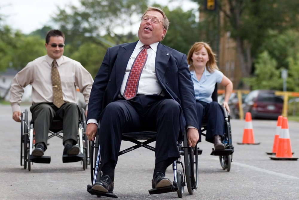 Mayor Don Atchison sighs with relief as he wins a celebrity wheel chair race in front of City Hall July 25, 2005. The event was to kick off the Sixth Annual Wheelchair Relay Campaign for the Canadian Paraplegic Association.