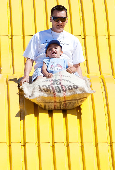 Three-year-old Preston Whitford looks terrified as he goes down the Kinsmen Giant Slide with his father Lawrence at Capital Ex in Edmonton on July 25, 2010.
